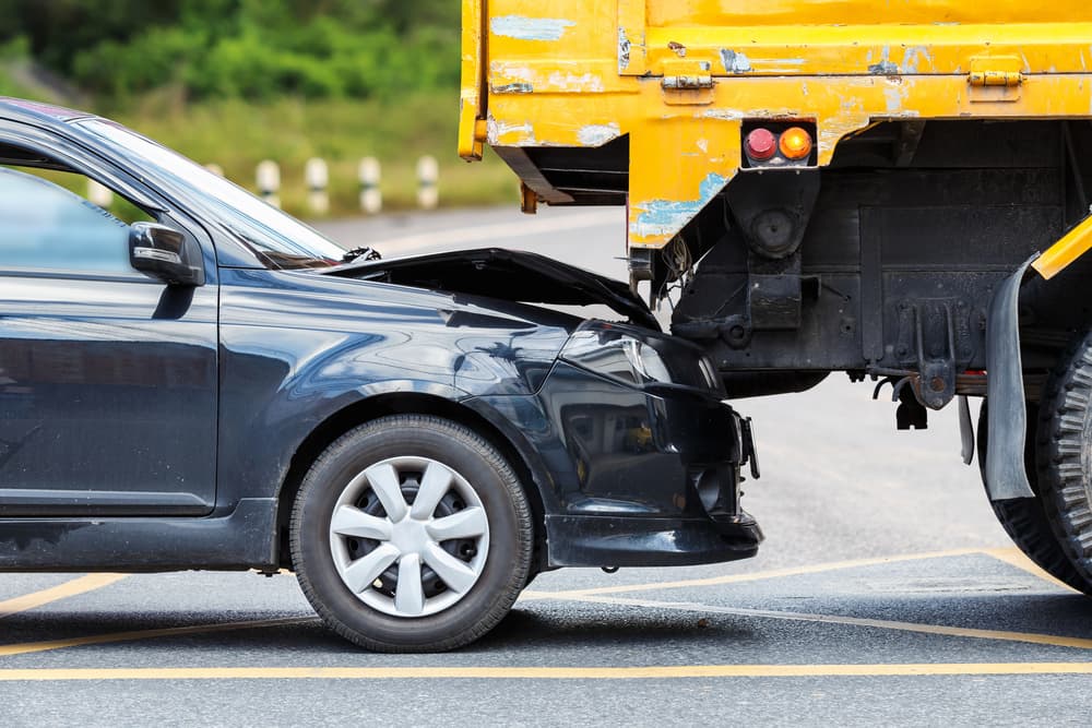 car crashing on a trucks rear-end