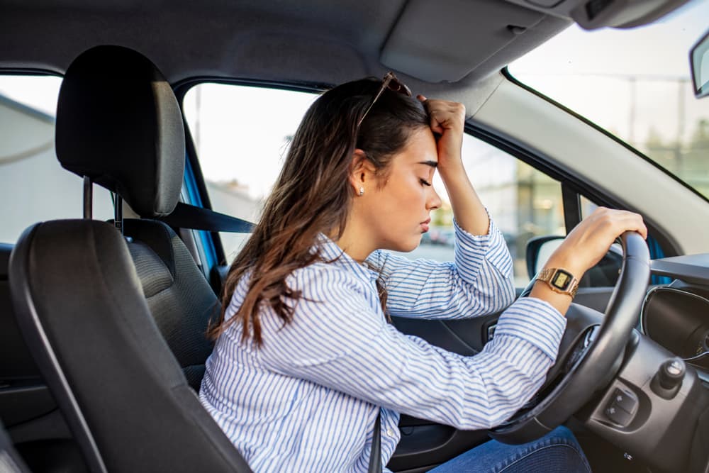 Stressed woman driving a car