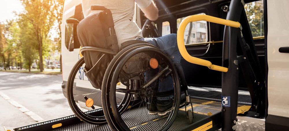 person who was injured at work getting into a bus on a wheelchair