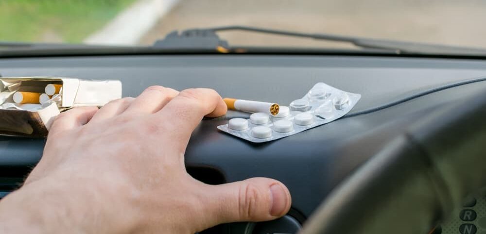 truck driving operating truck while reaching for pills and cigarettes; call a trusted Wilmington truck lawyer to hold the at fault party accountable