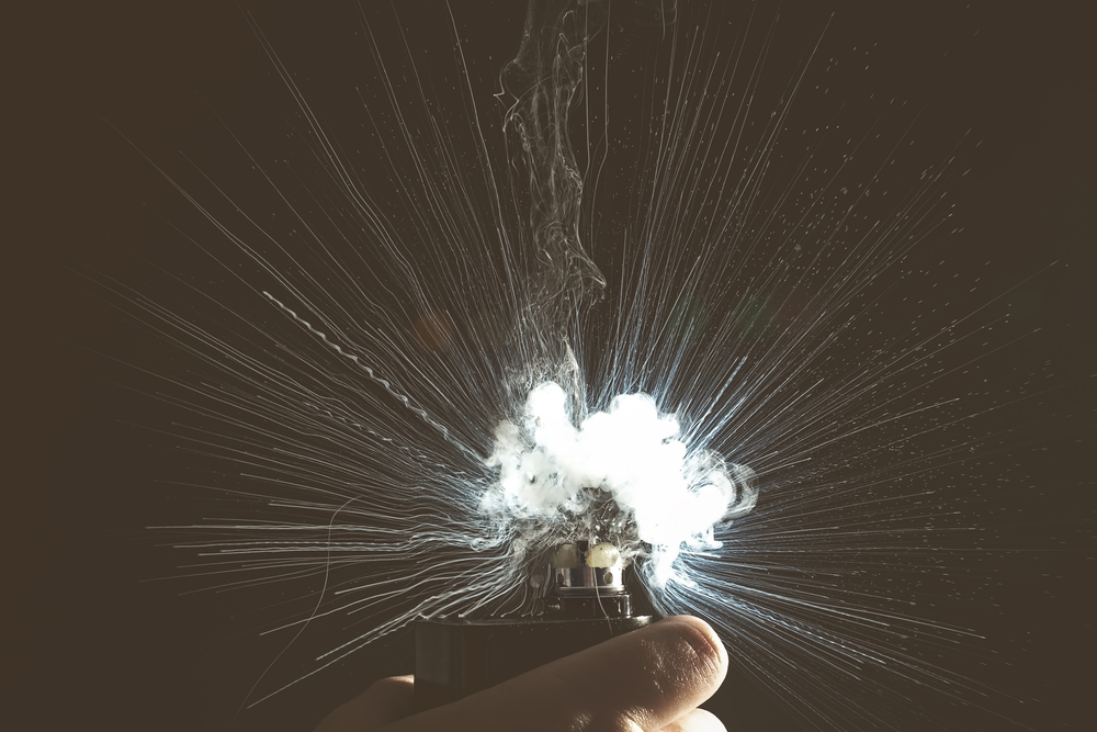 vape or e-cigarette held in one hand exploding
