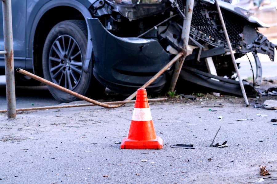 road cone against the background of a car broken in a road accident