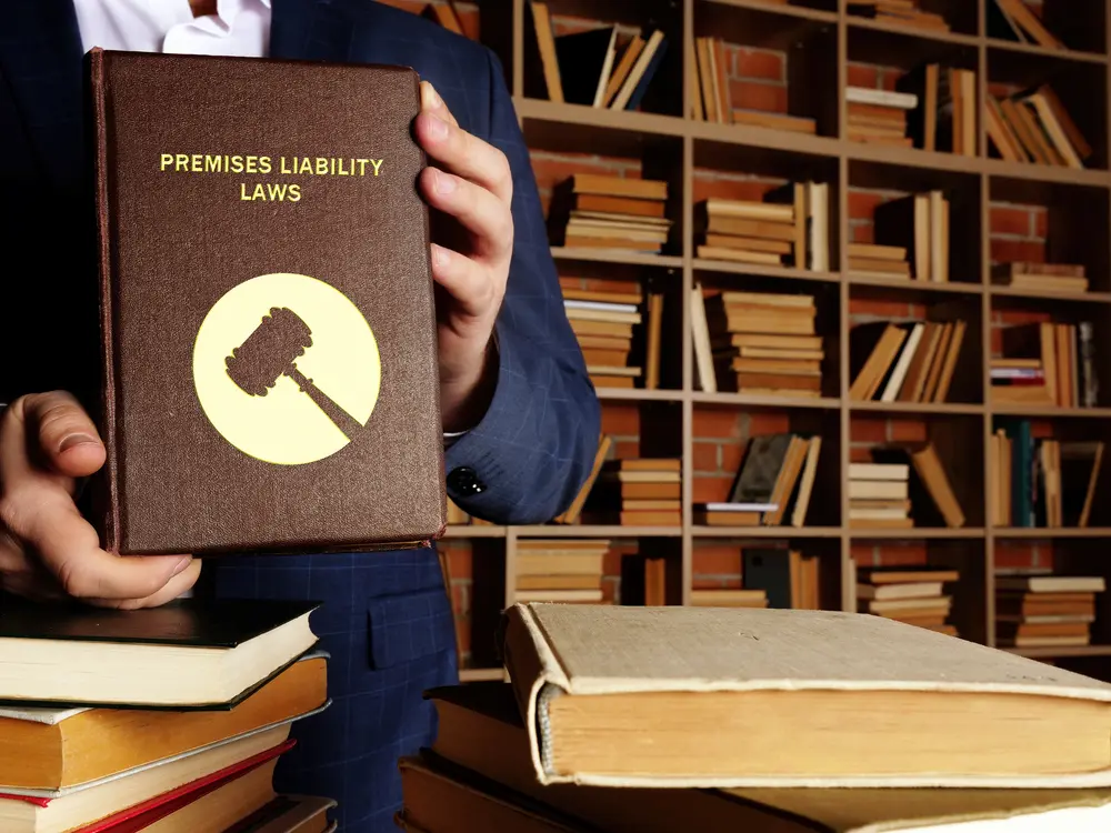 lawyer holding a premises liability law book
