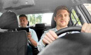 transport, vehicle and taxi concept - male driver driving car with passenger