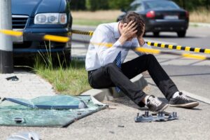 Sad man at a fatal road accident scene