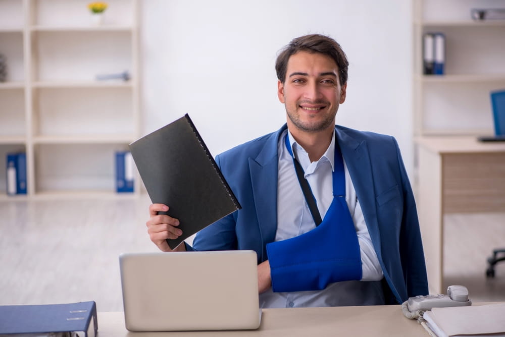 happy man with broken arm showing a document