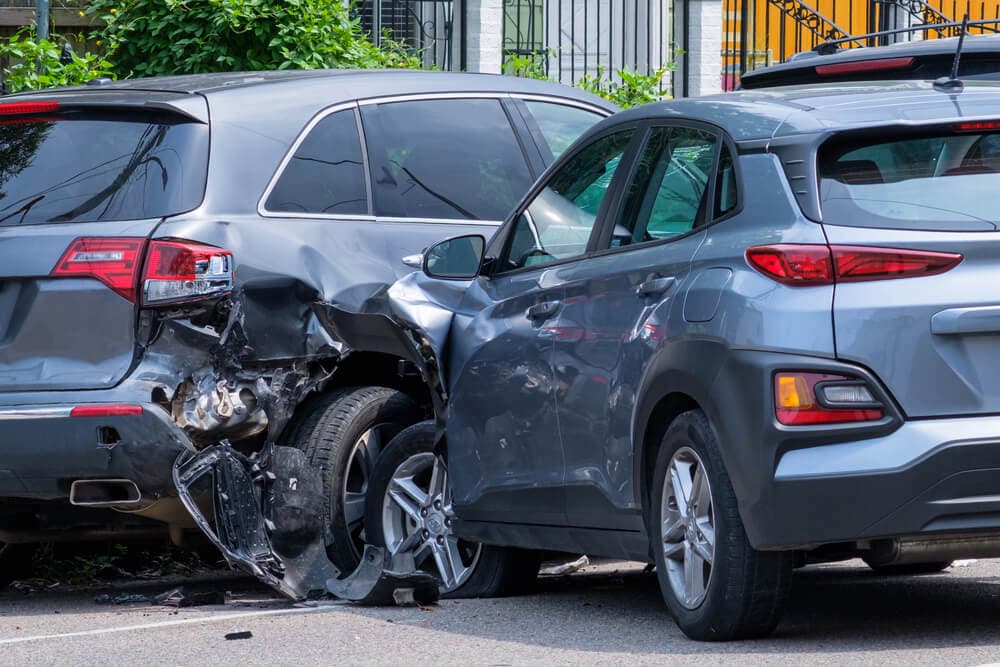 Car crashed into parked car on the street.